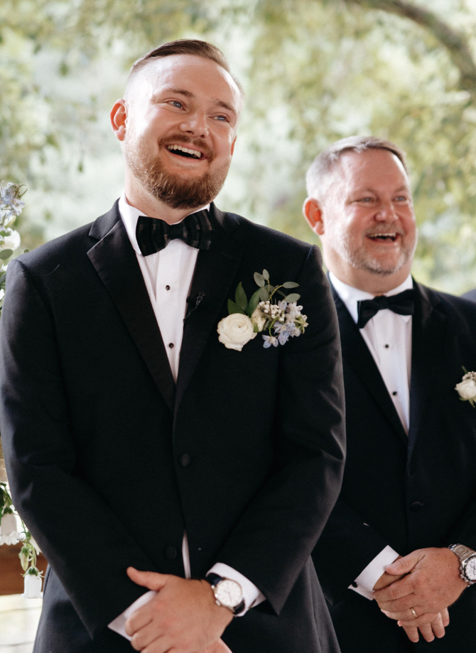 Groom watching bride walking down the aisle